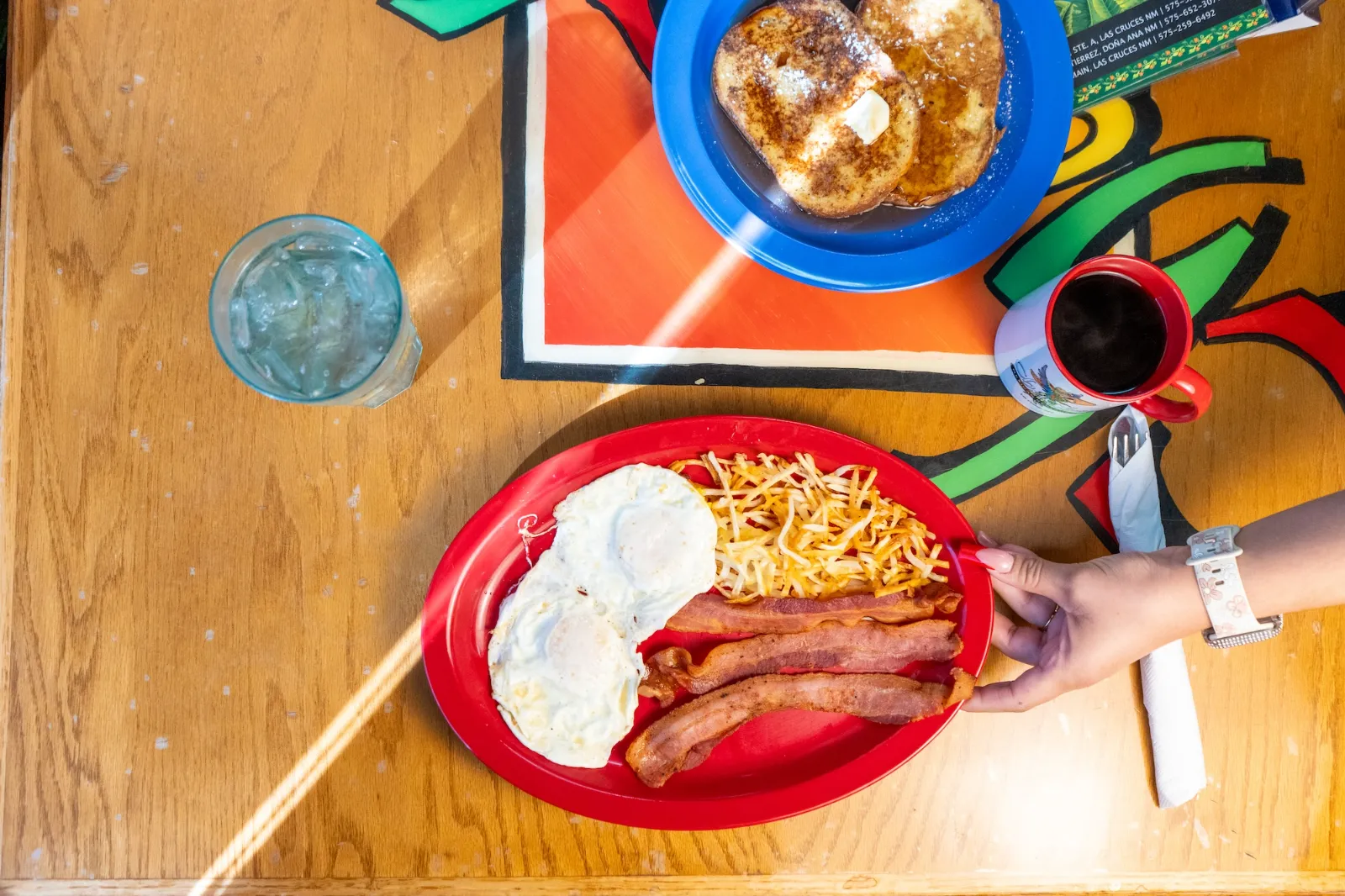 Bacon and eggs breakfast with french toast and coffee