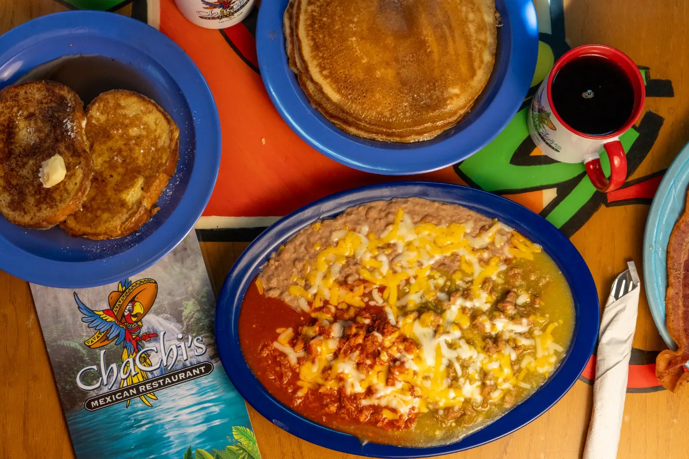 Breakfast spread with pancakes, french toast and red & green chile